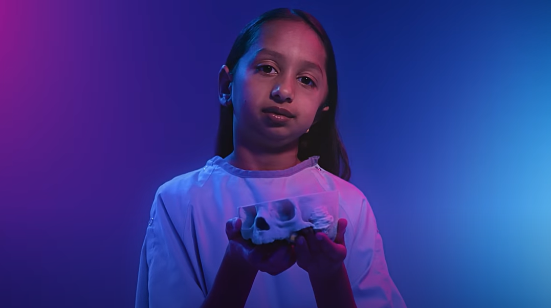 SickKids patient Chitra holding a 3D mold of her skull